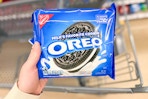 hand holding a pack of oreo cookies