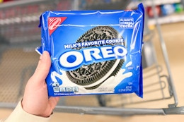 hand holding a pack of oreo cookies