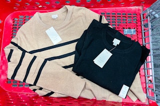 womens sweaters sitting in a target cart