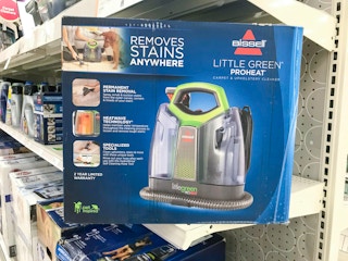 Bissell carpet cleaner in box on store shelf, turned diagonally toward the camera