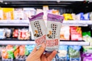 hand holding 2 perfect bars in front of produce at target