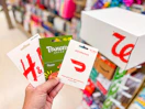 hand holding h and m, door dash, panera gift cards walgreens