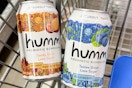 two cans of kombucha in a Walmart cart
