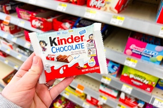 person holding a kinder chocolate bar