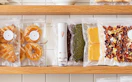 a vacuum sealer with vacuum-sealed food on a shelf