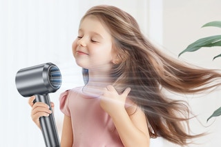 a girl using a hair dryer