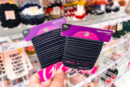 holding up two packs of Goody hair ties at Target