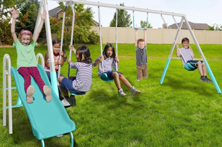 lifestyle image of children playing on a swingset