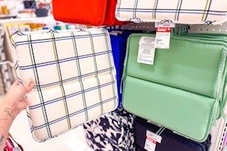 hand holding an outdoor chair seat cushion at target