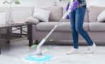a woman cleaning floors with a spin scrubber