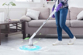 a woman cleaning floors with a spin scrubber