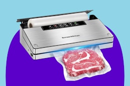 Bonsenkitchen Vacuum Sealer in silver with. bag roll inside and a piece of red meat being sealed