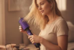 a woman blow drying her hair