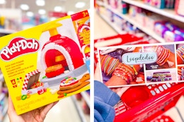 hand holding playdoh pizza kit and hand holding loopdeeloo kit over target cart