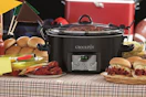 a crockpot on a table next to food