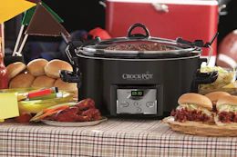 a crockpot on a table next to food