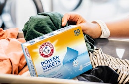 a box of laundry detergent sheets in a basket of laundry