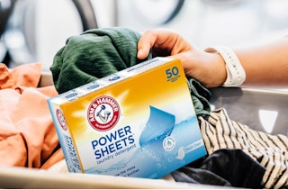 a box of laundry detergent sheets in a basket of laundry