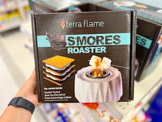 hand grabbing box of a s'mores roaster off of store shelf