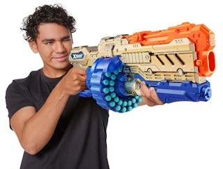 boy holding a zuru xshot dart shooter