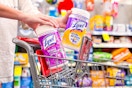 person putting 2 lysol wipe containers in a cart