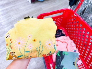 hand holding a disney women's sweatshirt at target