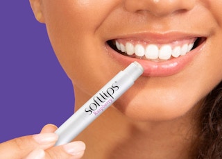 a person applying lip balm