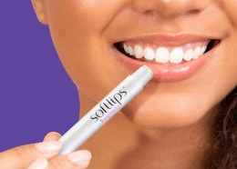 a person applying lip balm