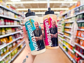 2 Flavortown sauces held up in center aisle at Walmart store
