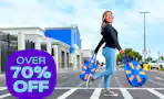 model walking across the parking lot walk way outside of Walmart