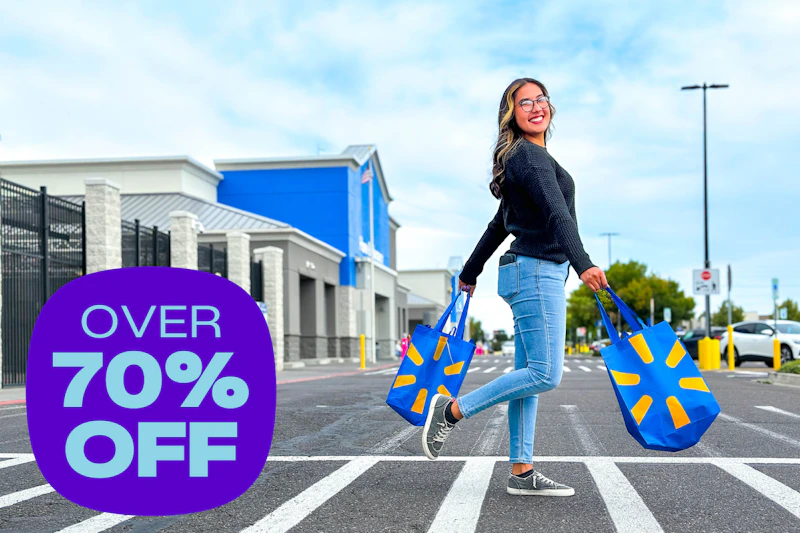 model walking across the parking lot walk way outside of Walmart