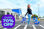 model walking across the parking lot walk way outside of Walmart