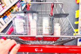 person pushing a cart with olaplex haircare in it
