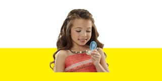 a girl holding a green and brown necklace