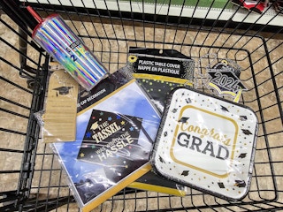 graduation supplies in a cart