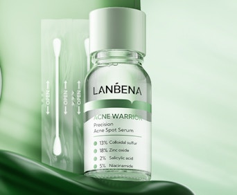 a bottle of spot serum and cotton swabs 