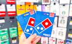 hand holding dominos gift cards