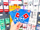 hand holding dominos gift cards