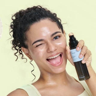 a person holding a bottle of skin serum