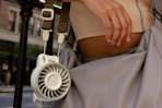 a portable fan hanging on a woman