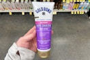 hand holding a bottle of gold bond age renew crepe corrector lotion
