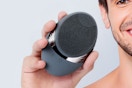 Man holding the COSLUS Facial Cleansing Brush Face Scrubber in hand.