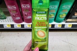 hand holding garnier fructis shampoo at dollar general