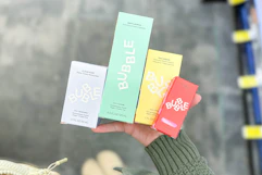 person holding bubble skincare products