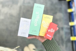 person holding bubble skincare products