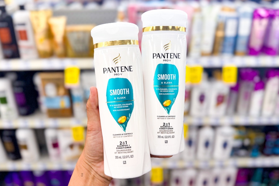 hand holding a bottle of pantene shampoo and conditioner