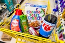 rc cola, cinnamon toast crunch, garnier products in a yellow shopping cart