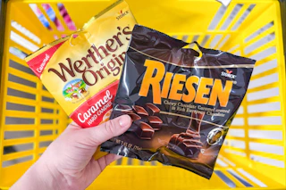 hand holding werther-s and riesen candies