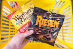 hand holding werther-s and riesen candies