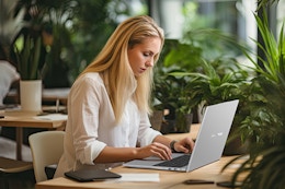 Woman working on laptop.